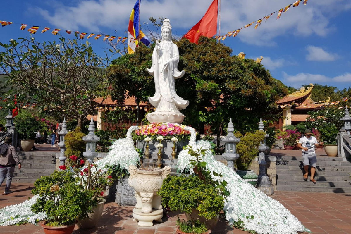 Traditional gate of Van Son Pagoda with curved roof and Buddhist motifs